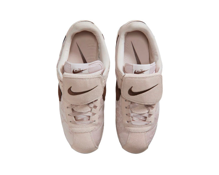 Nike Cortez low-top sneakers with lace-up front and Nike Swoosh on beige upper