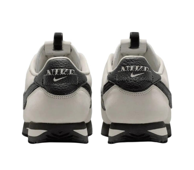 Cortez sneakers heel view, cream leather with black heel tabs and Nike logo