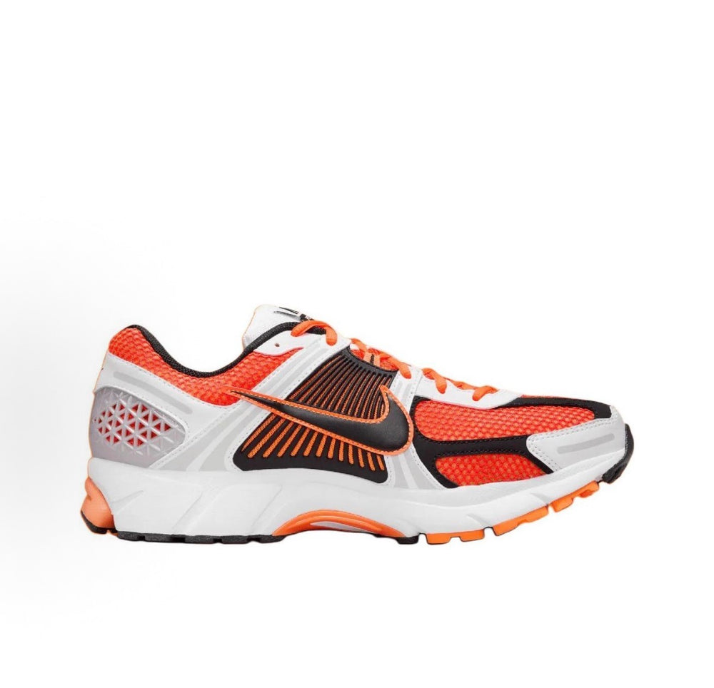 Nike Zoom Vomero 5 SP running shoe in orange knit with black and gray panels.