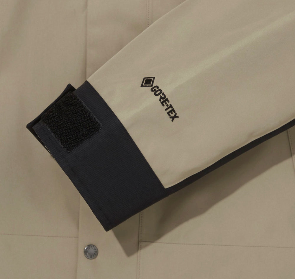 GORE-TEX logo on tan sleeve cuff with black strap
